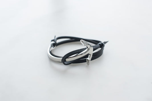 Black leather anchor bracelet for men with silver metal hook clasp on white background