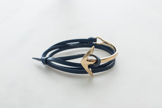 Navy leather anchor bracelet for men with gold-tone hook clasp on white background