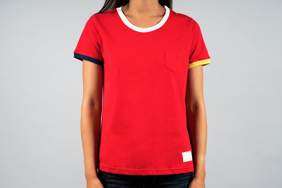 Red Sports Tee with white neckline, navy and gold sleeve stripes, front pocket detail on women's casual shirt.